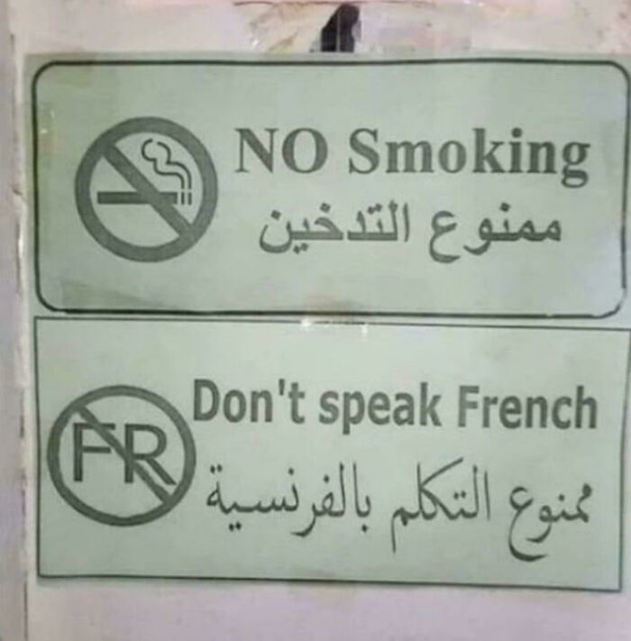 Funny sign prohibiting smoking and speaking French with symbols and bilingual text