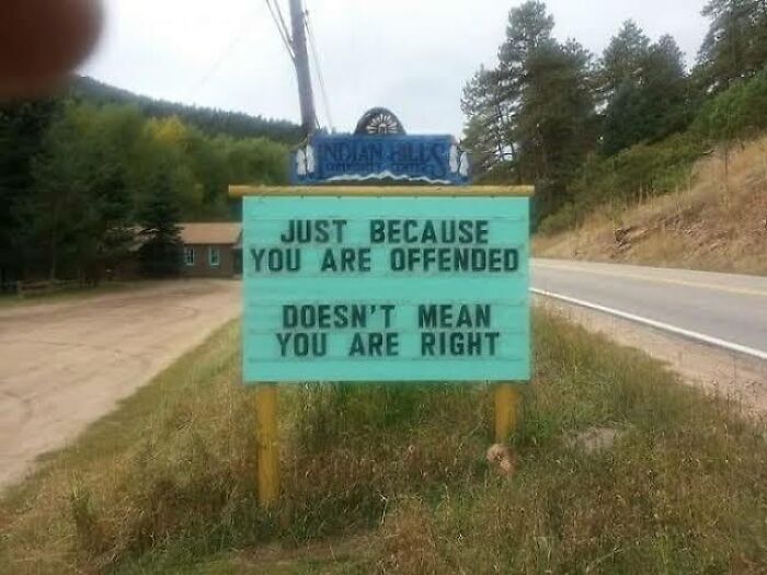 Humorous road sign stating just because you are offended doesn't mean you are right