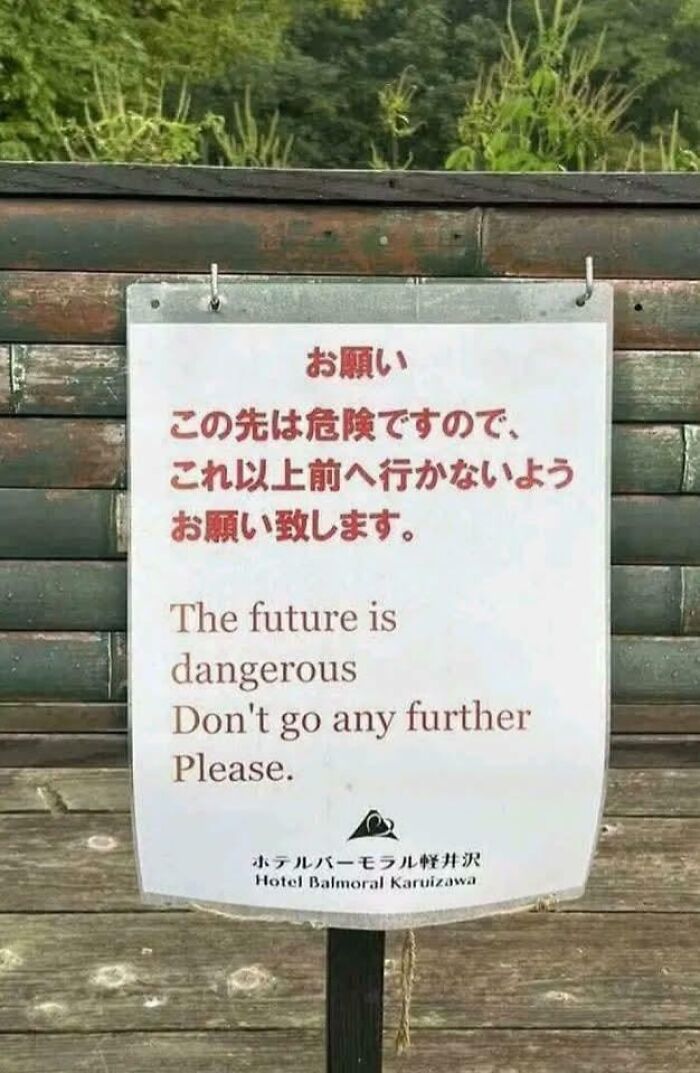 Humorous warning sign in English and Japanese about dangerous future