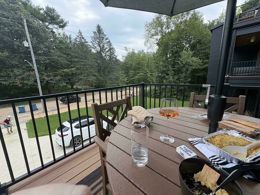 Outdoor balcony scene with food and drinks showing Airbnb stay fail