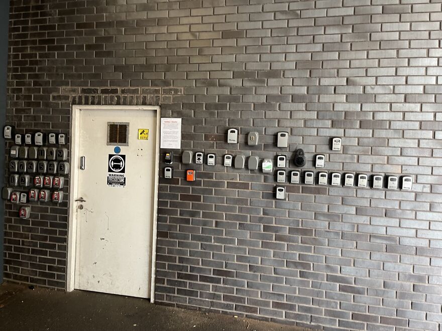 Wall lined with numerous electrical meters by a door highlighting hotel and Airbnb fails