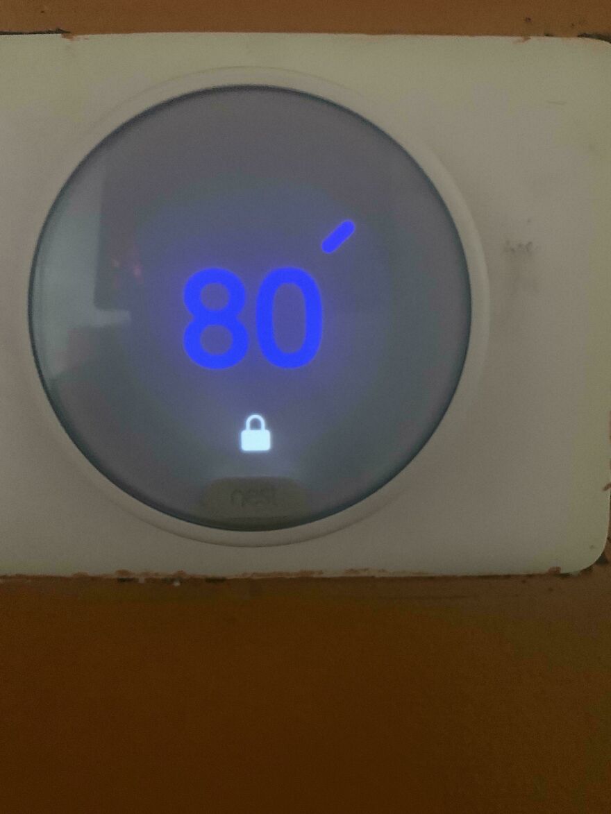 Digital thermostat displaying 80 degrees with lock icon illustrating hotel and Airbnb fails