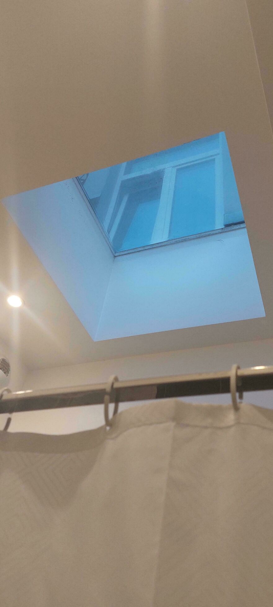 Bathroom skylight showing a window looking into another room in hotel fail