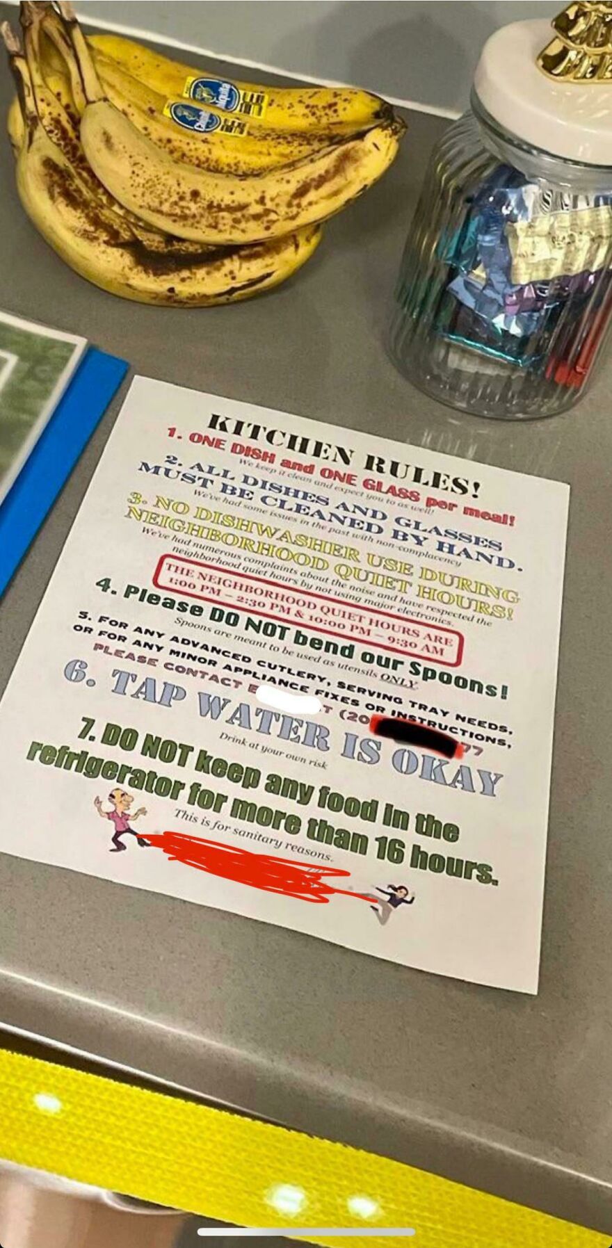 Kitchen rules sign with bananas and candy jar on hotel counter