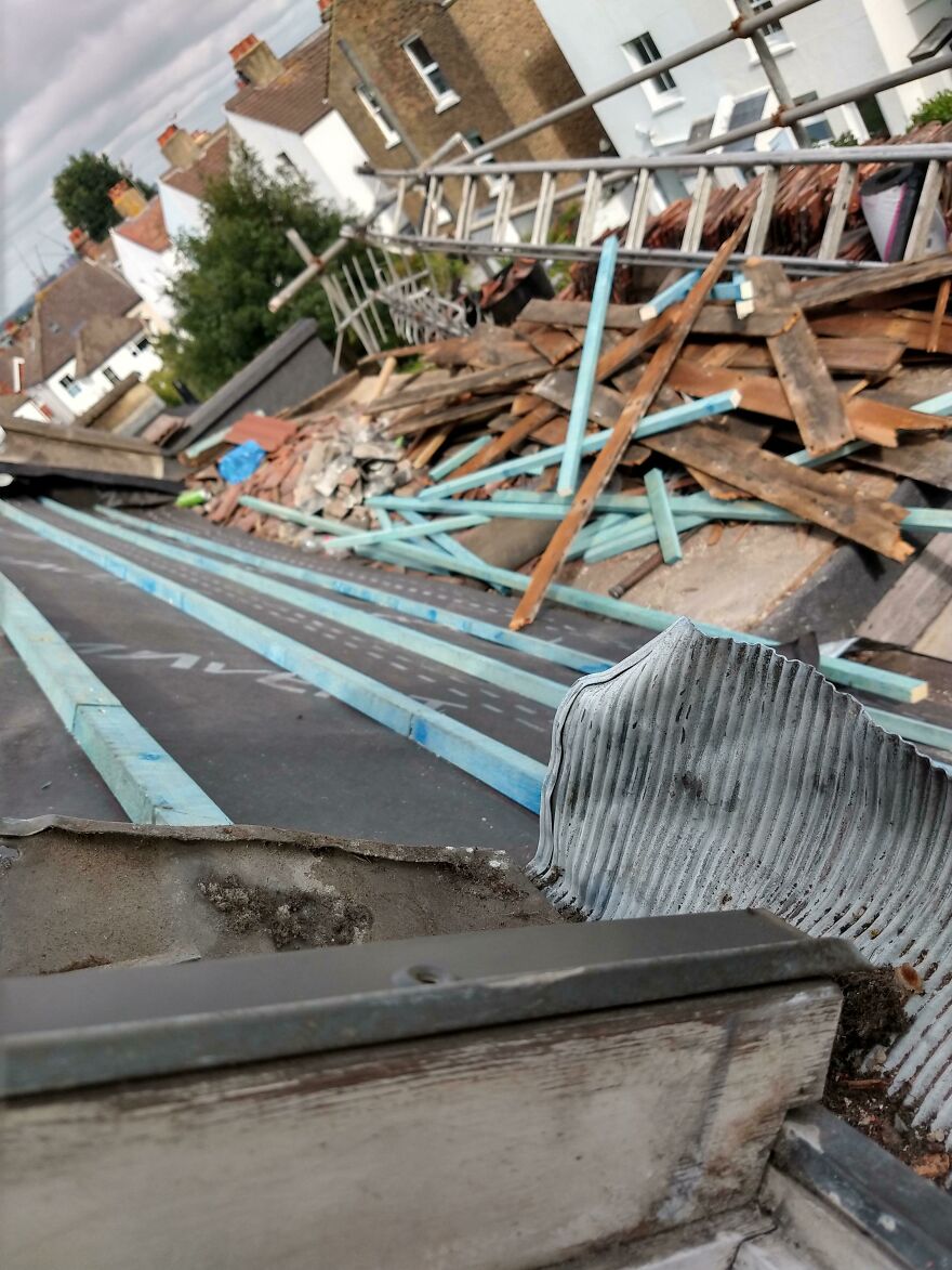 Damaged hotel roof with scattered wood and construction debris