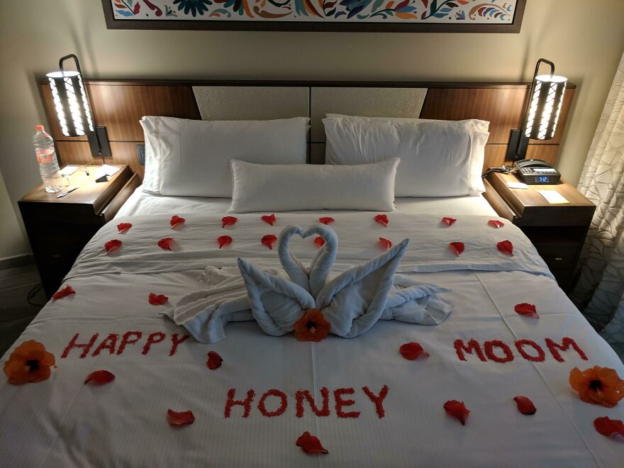 Hotel honeymoon bed with towel swans and flower petals decoration