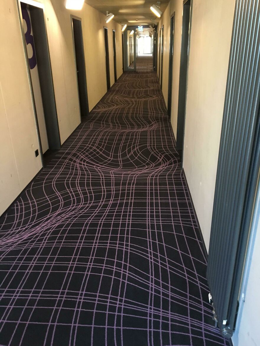 Hotel corridor carpet with distorted optical illusion pattern