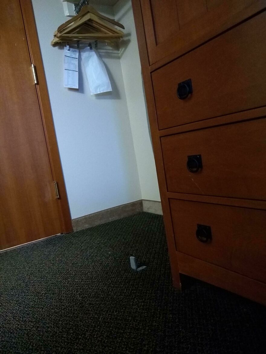 Hotel room corner with furniture and part of carpet torn or damaged