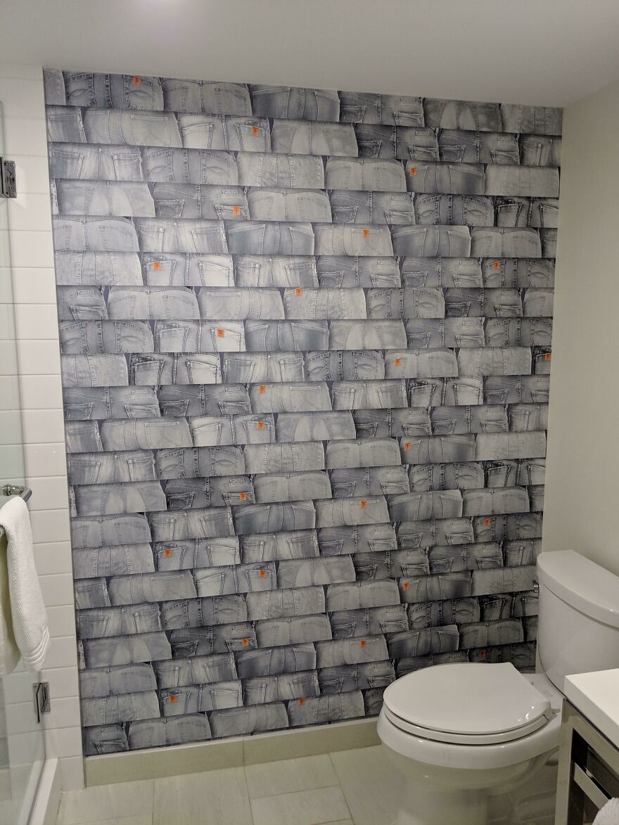 Bathroom wall decorated with wallpaper patterned like jean pockets in hotel