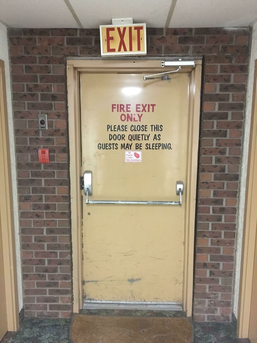 Fire exit door with sign reminding to close quietly for sleeping guests hotel fails
