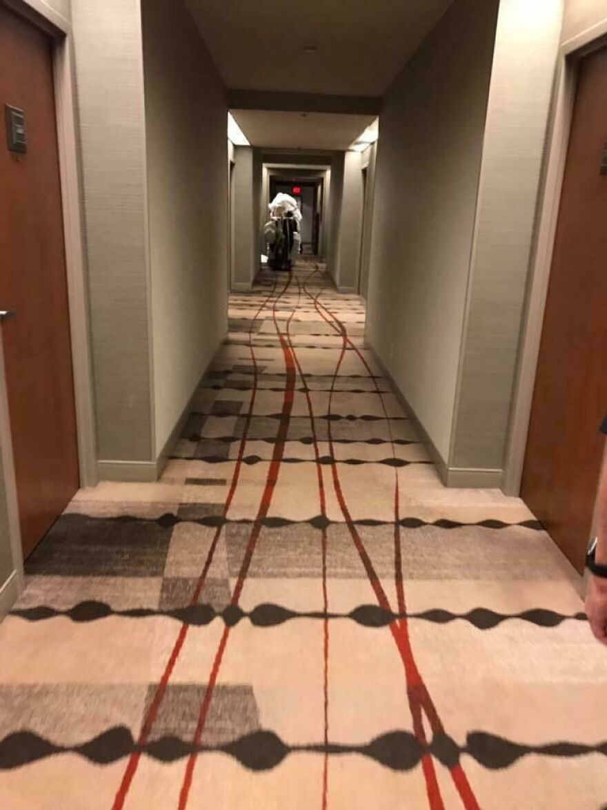 Hotel hallway carpet with confusing red and black patterns hotel fails