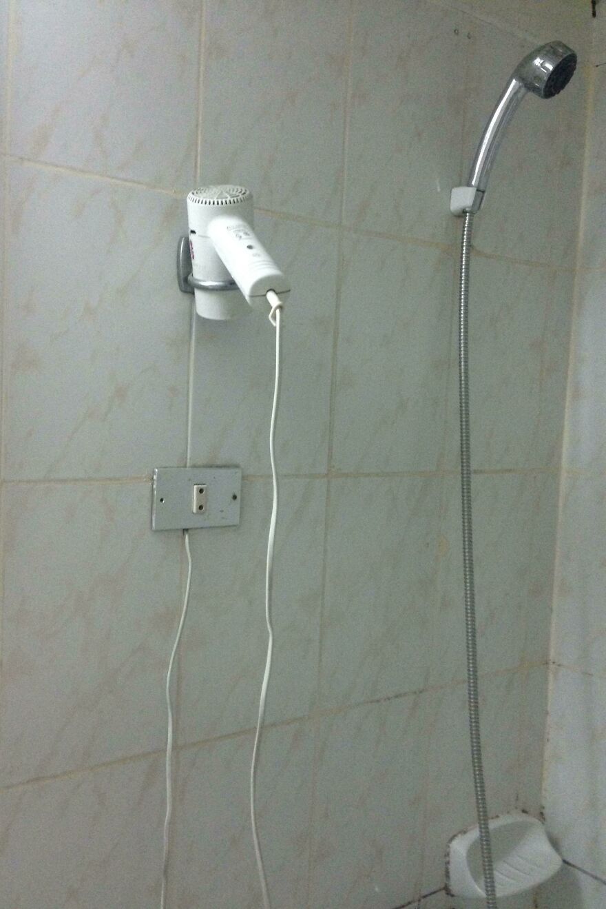 Bathroom wall with hair dryer plug dangerously close to shower hotel fails