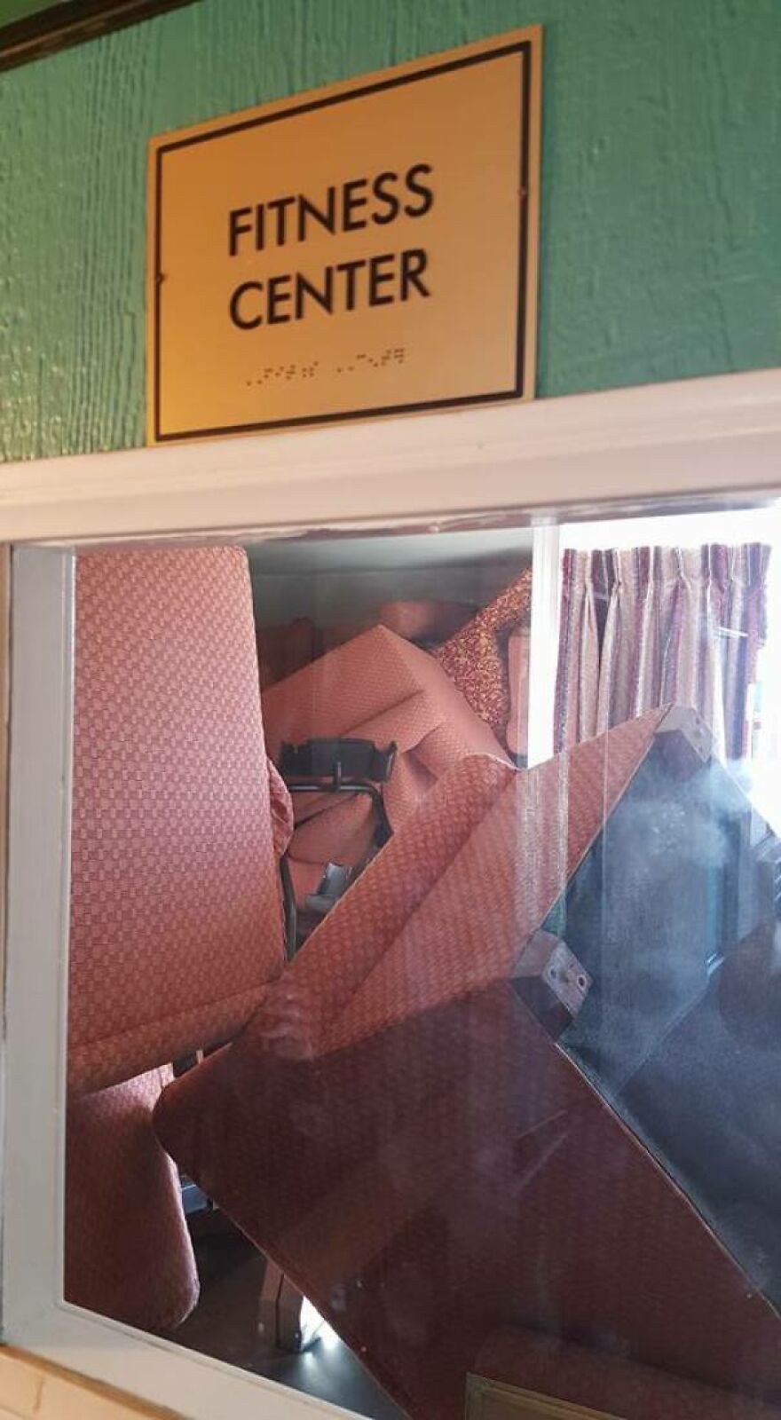 Fitness center room packed with stacked chairs blocking access in hotel fail