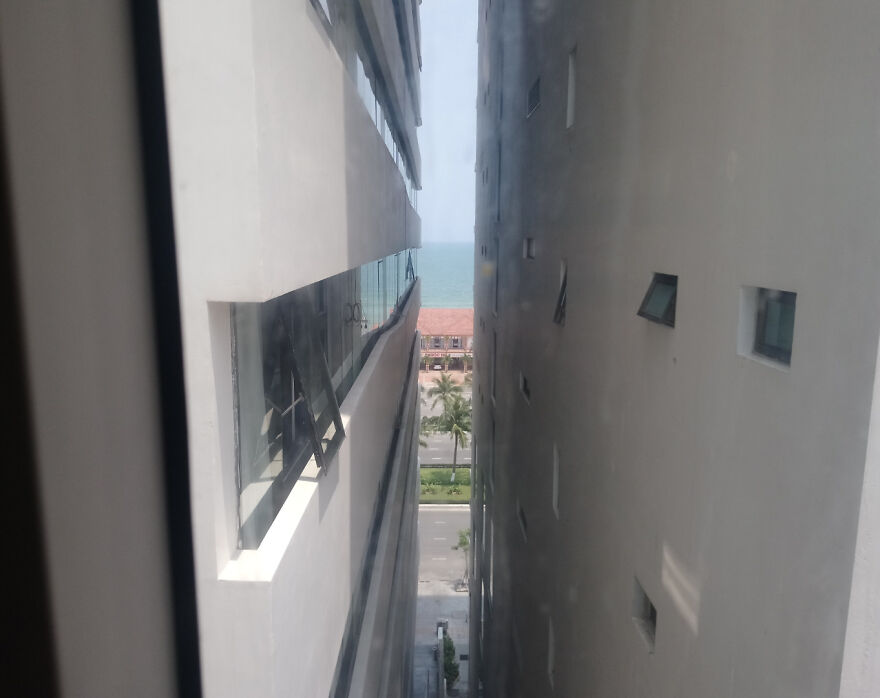 Narrow hotel view blocked by buildings with limited ocean view in a hotel fail