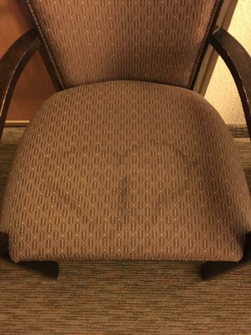 Hotel chair seat pattern camouflages with carpet, creating optical illusion