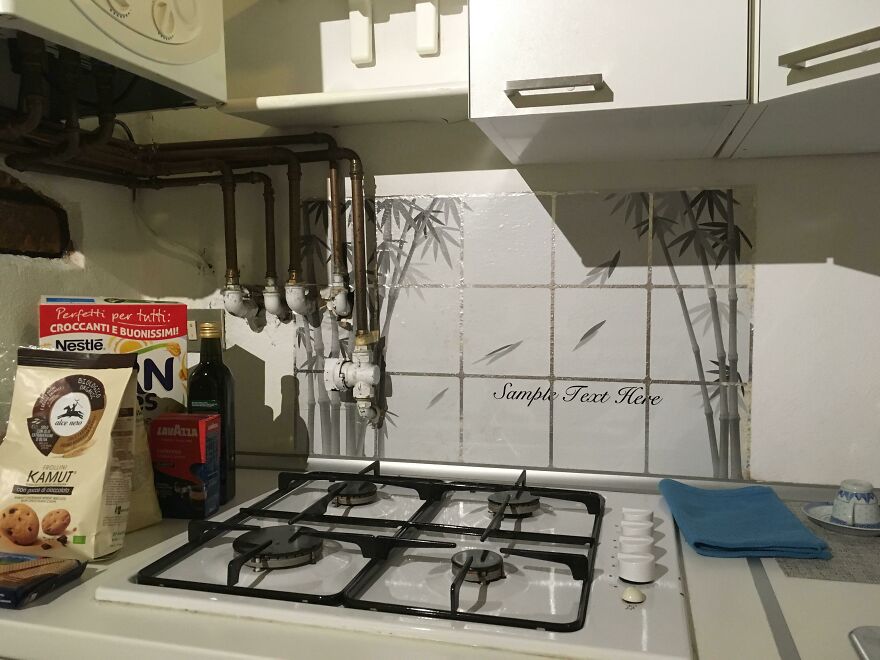 Kitchen gas stove with cluttered pipes and food items in hotel Airbnb fail
