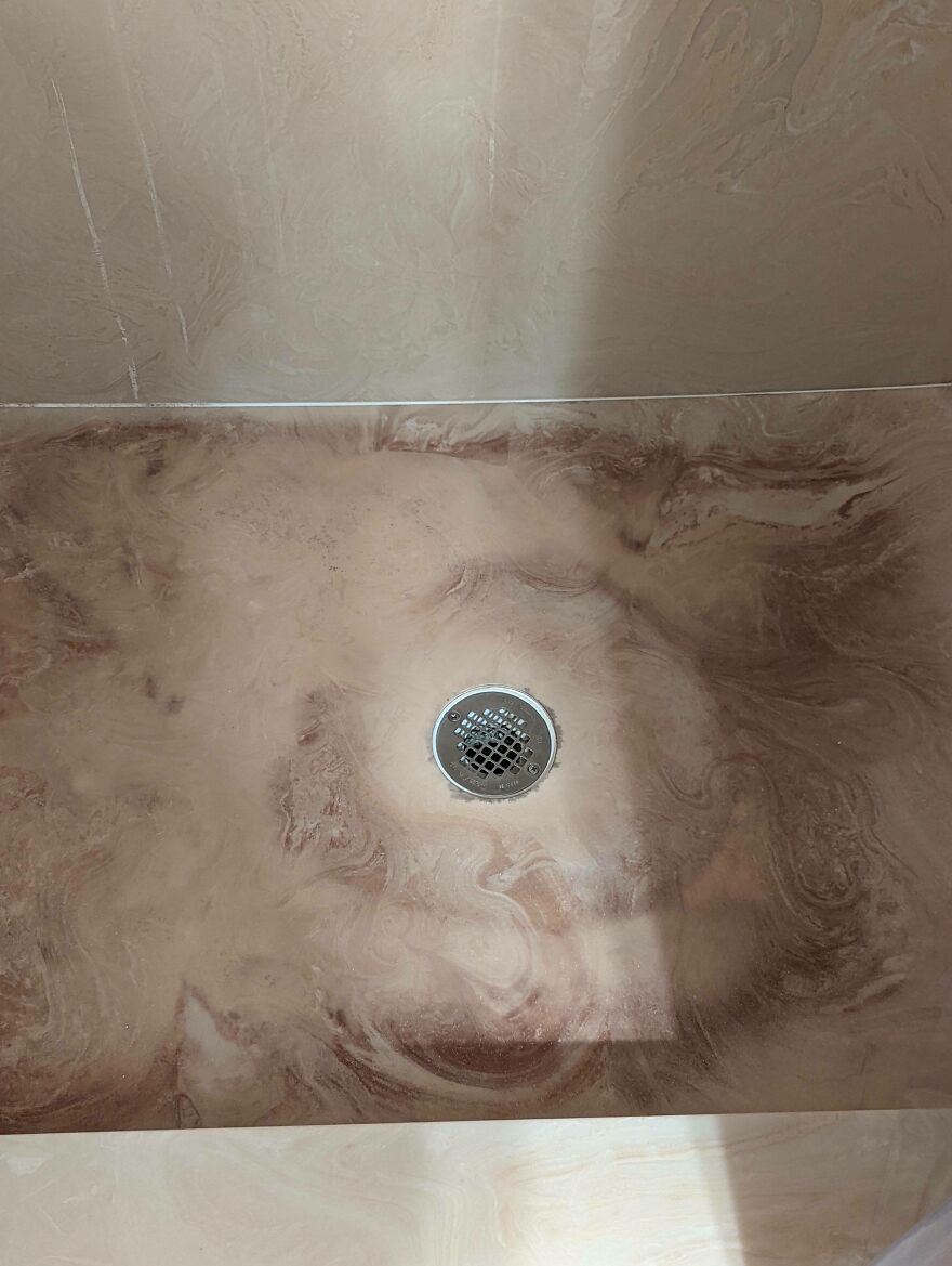 Shower floor with odd discoloration around the drain