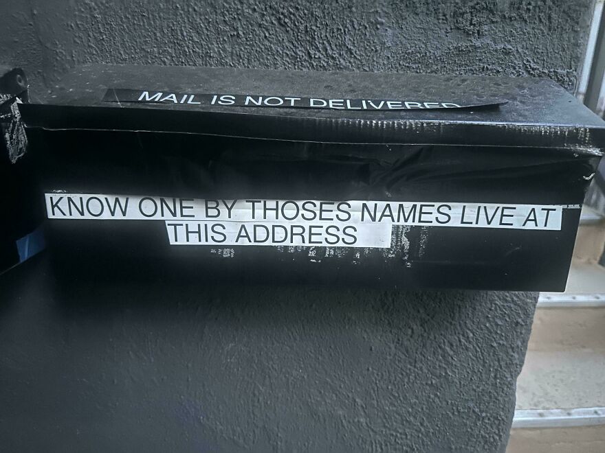 Mailbox with sign using incorrect grammar about known residents at address