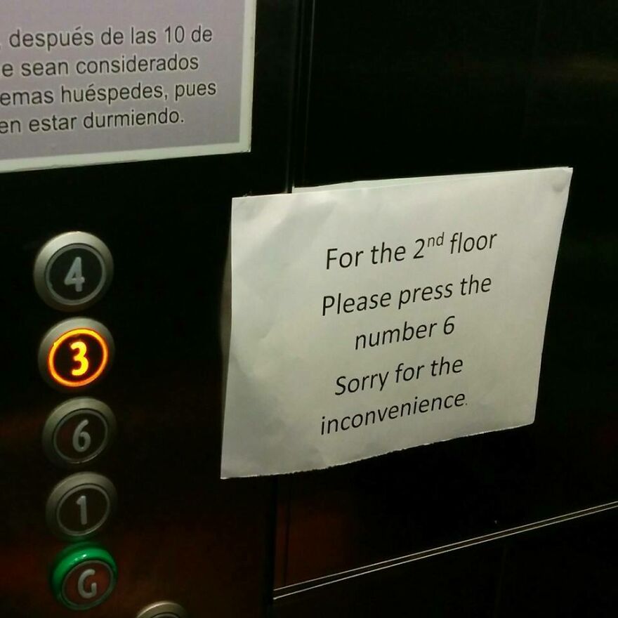 Elevator panel with confusing sign instructing to press wrong button