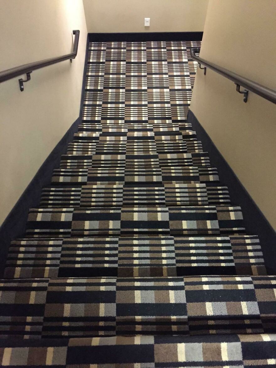 Carpeted stairs with confusing pattern blending steps in hotel
