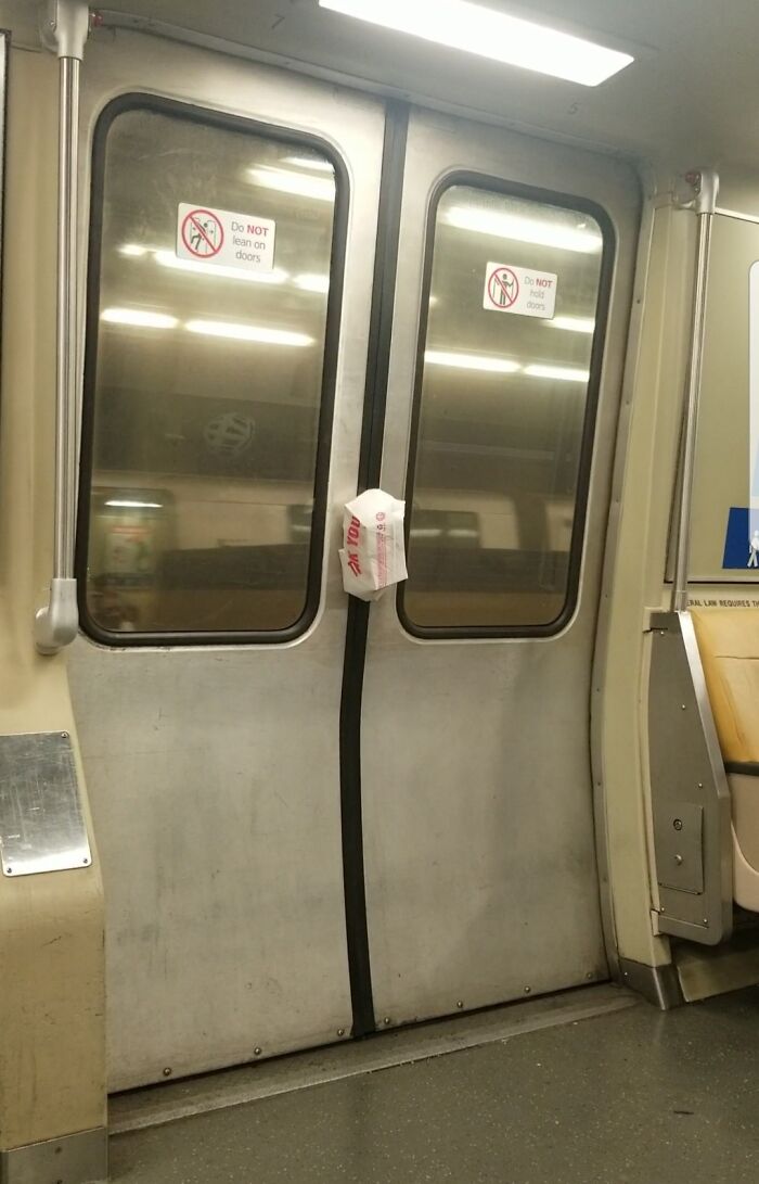 Takeaway bag caught in the closed doors of a public transport train