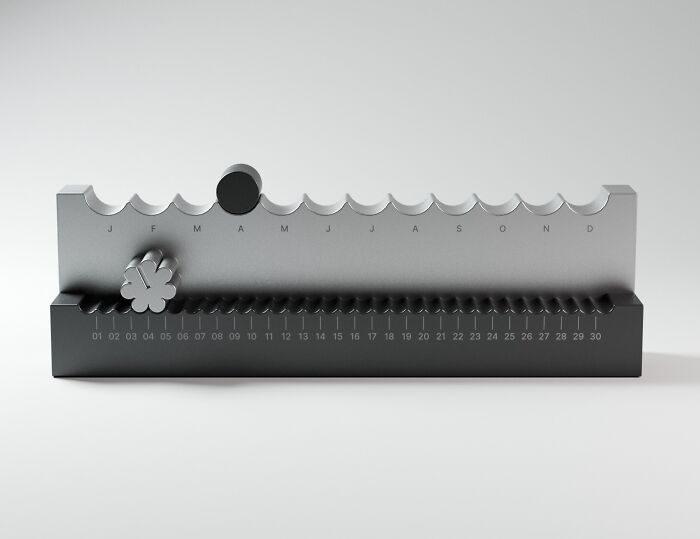 Modern desk calendar with movable markers for months and days in minimalist style