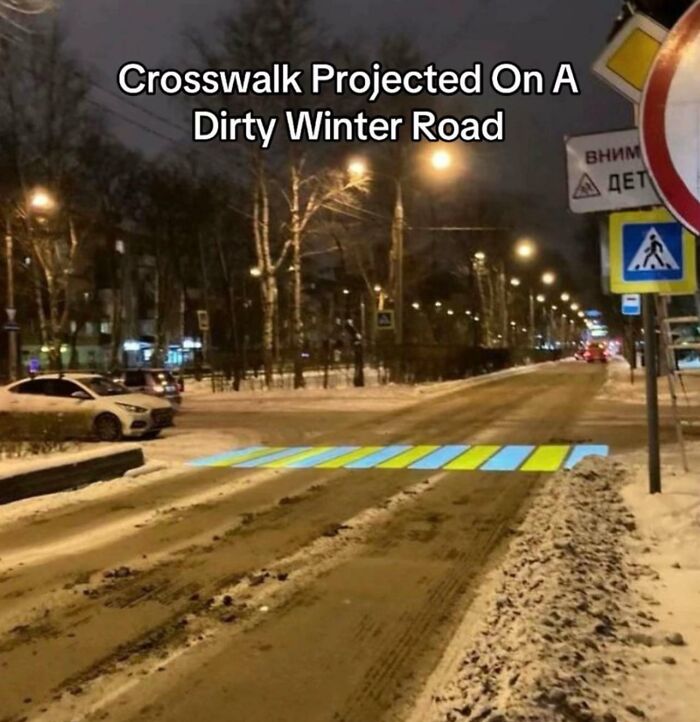 Crosswalk projected on a dirty winter road with bright lines for visibility
