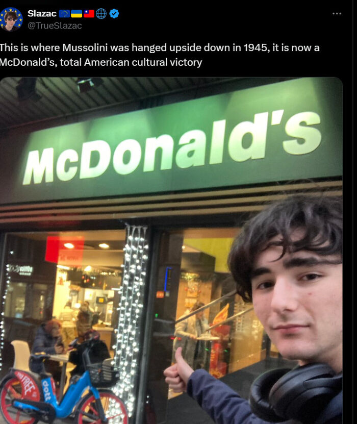 Person giving thumbs up in front of McDonald's, noting American cultural influence
