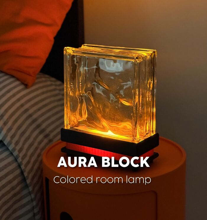 3D printed aura block colored room lamp glowing on a bedside table