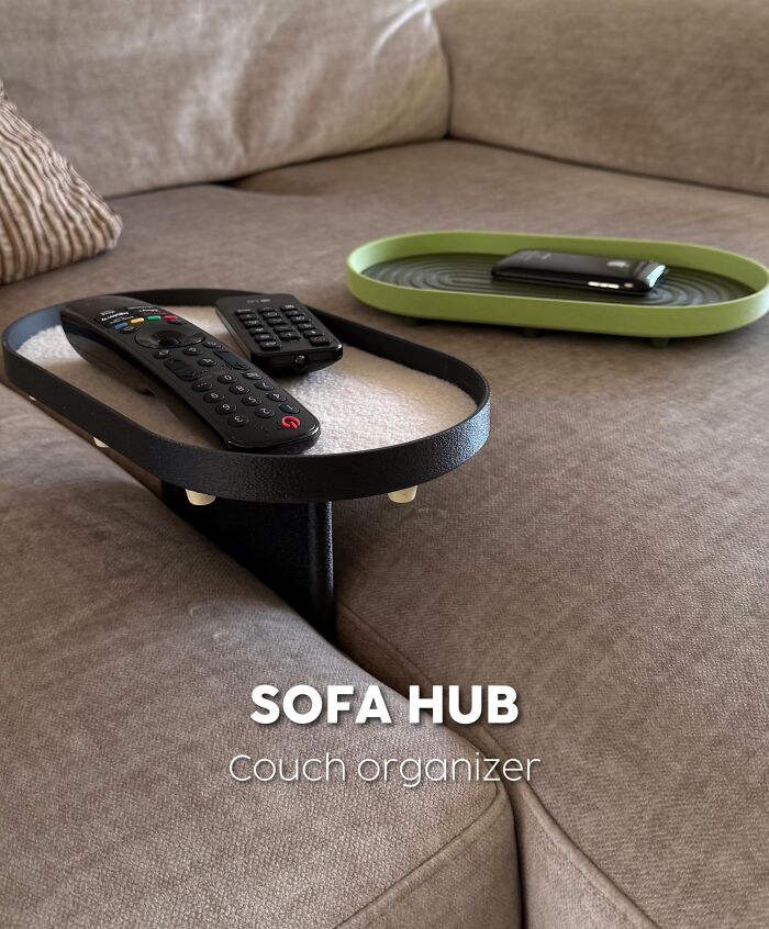3D printed sofa hub organizer holding remotes on a couch armrest