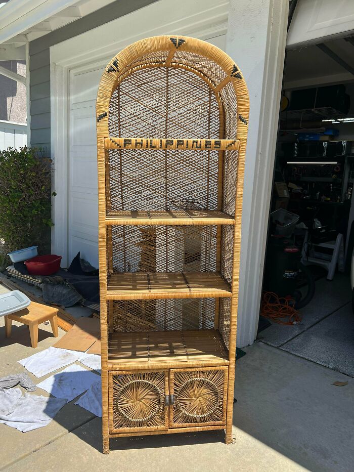 An arched wicker shelf unit with the word Philippines, found as one of many unique thrift store finds.