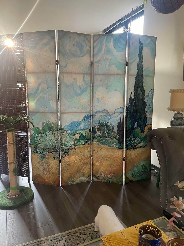A decorative room divider screen featuring Vincent van Gogh artwork, a great thrift store find.
