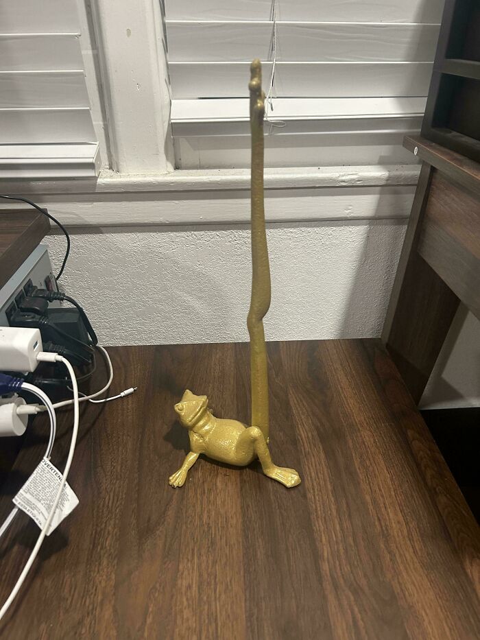 A gold-painted frog-shaped paper towel holder, one of many unique thrift store finds