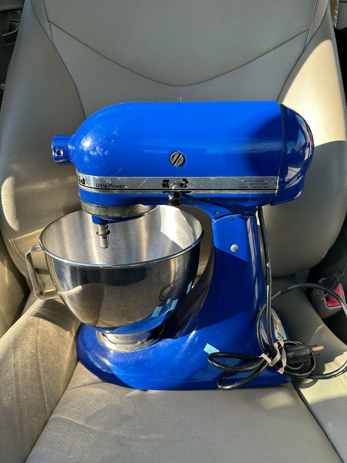 A vibrant blue KitchenAid stand mixer with a stainless steel bowl, a lucky find from a thrift store