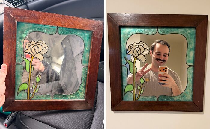 A man poses with a stained glass mirror featuring a rose, a unique thrift store find.