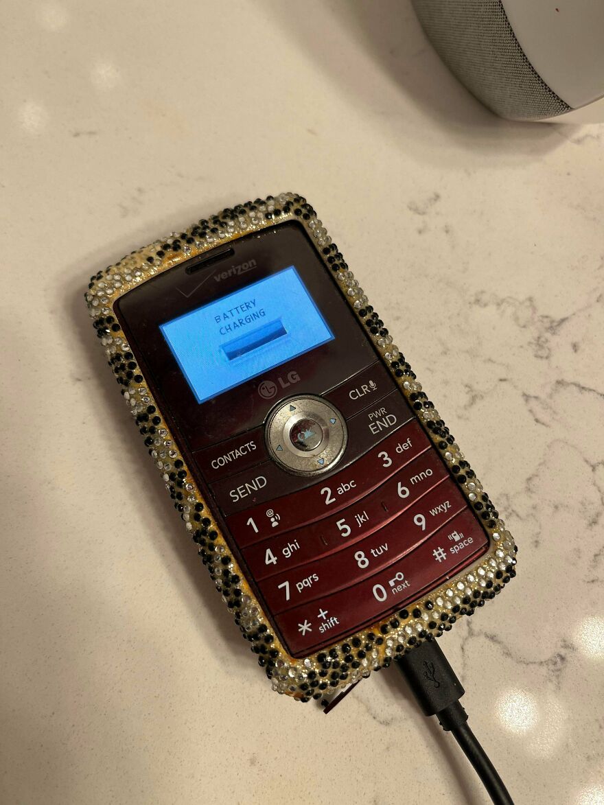 An old LG phone decorated with rhinestones showing early 2000s mobile technology and design trends.