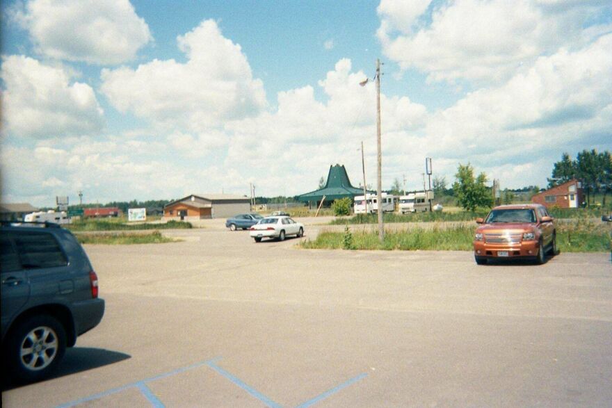 An empty parking lot in front of a retro diner, capturing early 2000s nostalgic vibes.