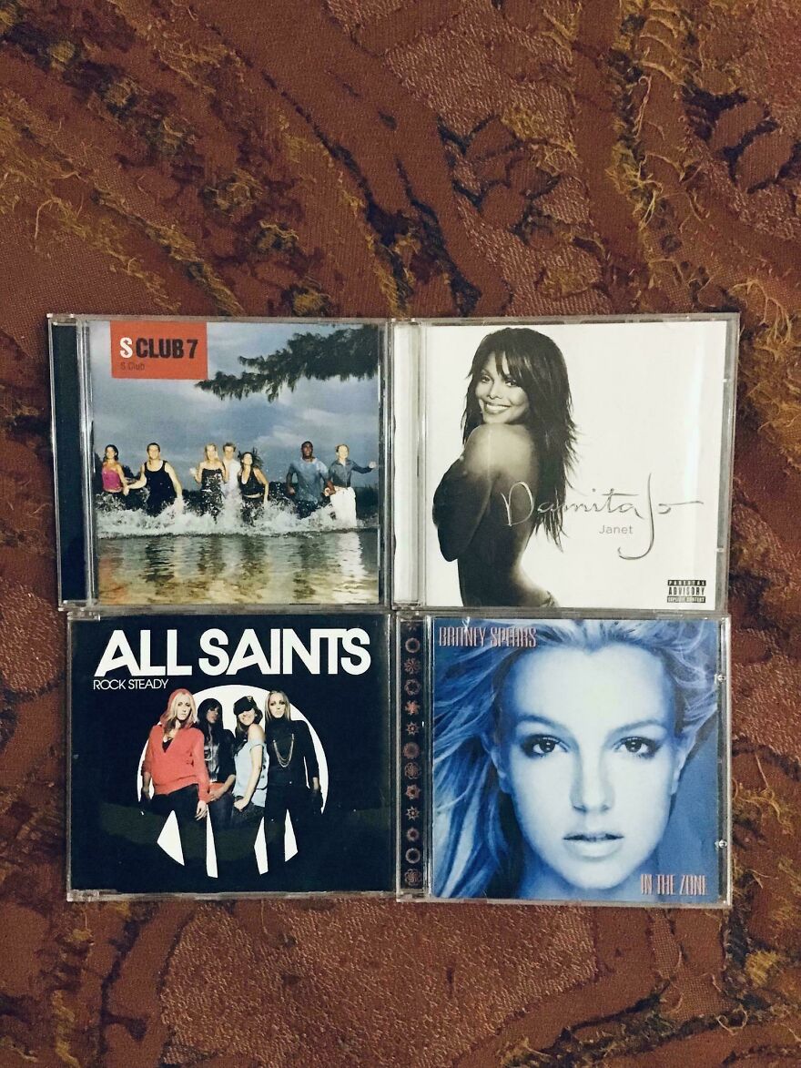 Four classic music CDs from the early 2000s, including albums by Britney Spears and S Club 7.