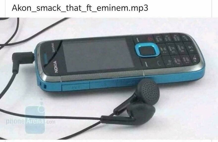 A classic blue Nokia phone with wired earphones playing a song from the early 2000s