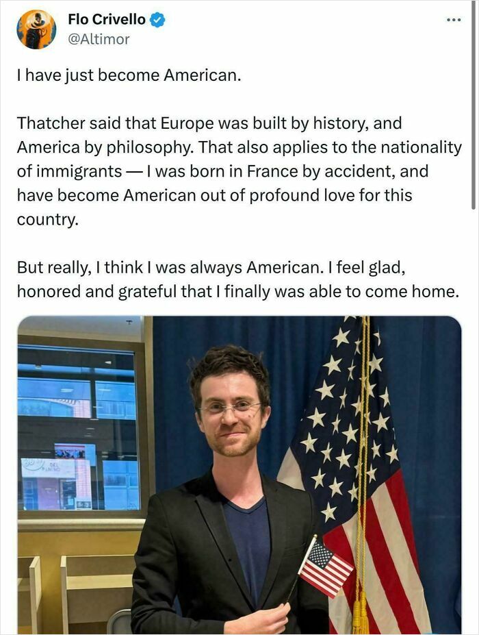Man holding U.S. flag and smiling next to American flags in a post about becoming American