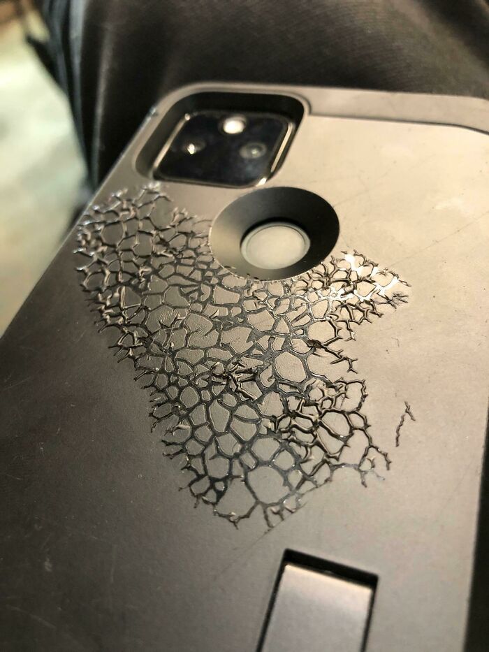 A black smartphone case showing a cracked pattern under heat in one of the interesting photos