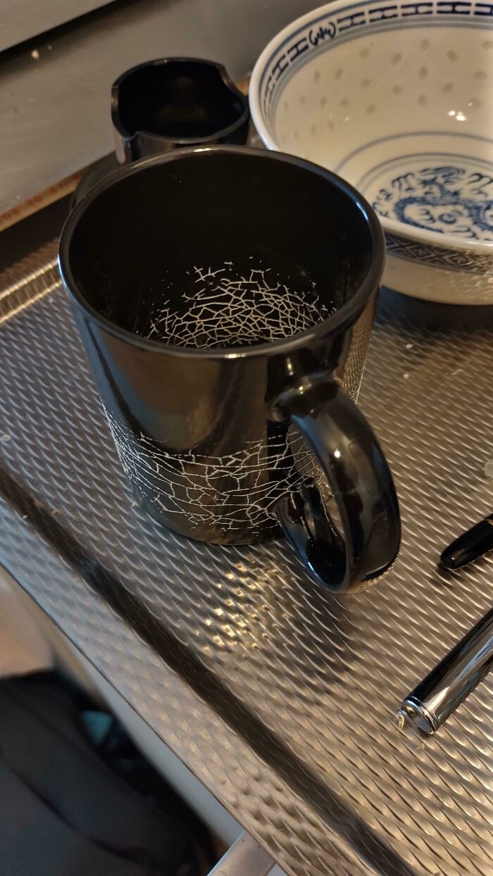 Interesting and cool photos of dried milk forming a spiderweb pattern inside a black mug