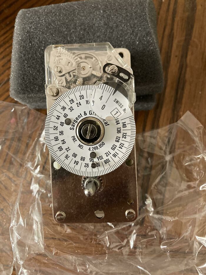 Interesting and cool photos of a mechanical timer on a wooden table