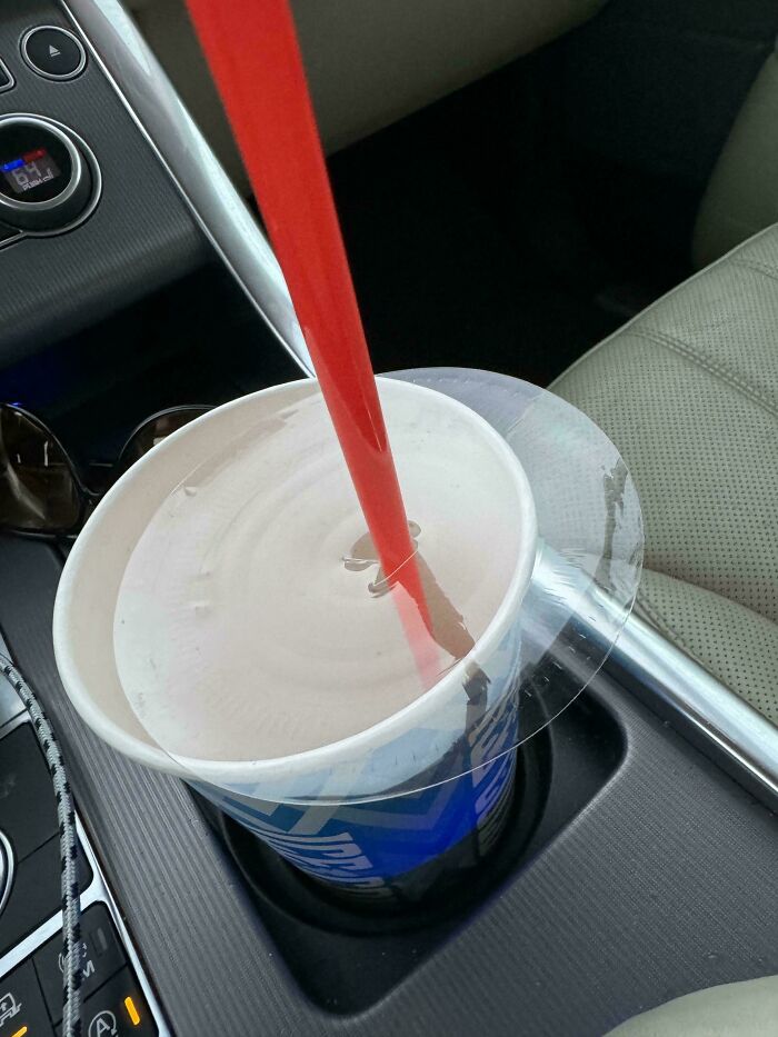 A clear plastic lid on a cup that was miscut, leaving it completely solid, showcasing interesting photos of manufacturing errors.