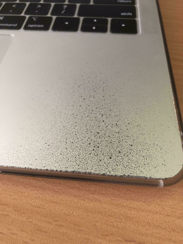 Cool photo of a laptop palm rest worn down to the aluminum after years of use