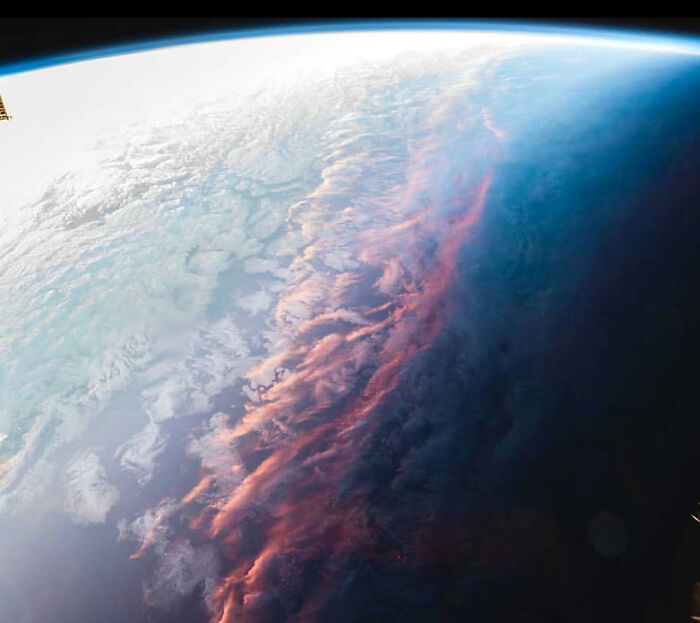 An interesting and cool photo of a sunset view on Earth taken from space showing clouds with a pink hue