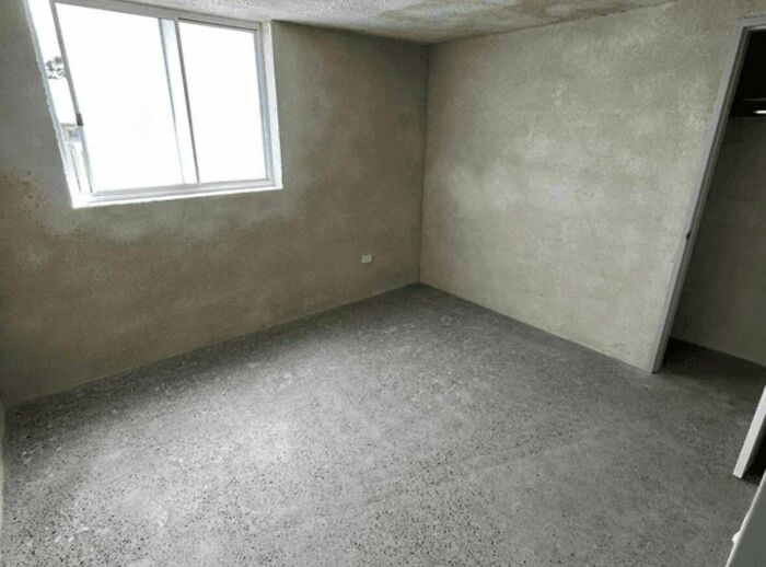 Bare unfinished concrete room showing the struggles of renting and booking online