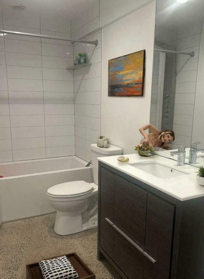 A photo of a bathroom with a creepy reflection from a renting and booking listing.