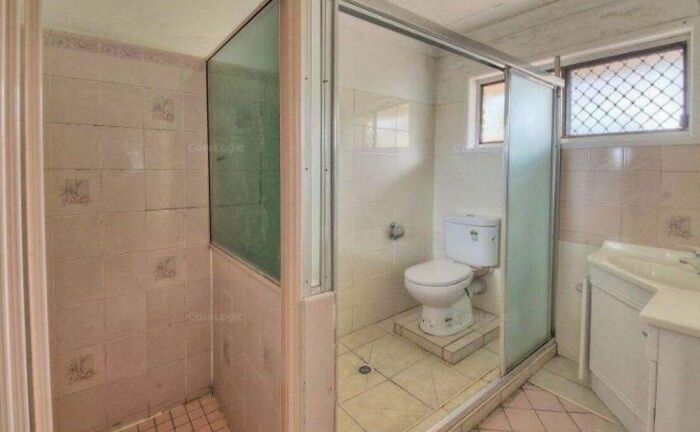 Extremely narrow bathroom layout highlighting poor renting and booking accommodation choices