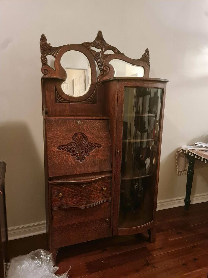Antique wooden secretary desk with glass cabinet, one of many old treasures found by antique lovers.